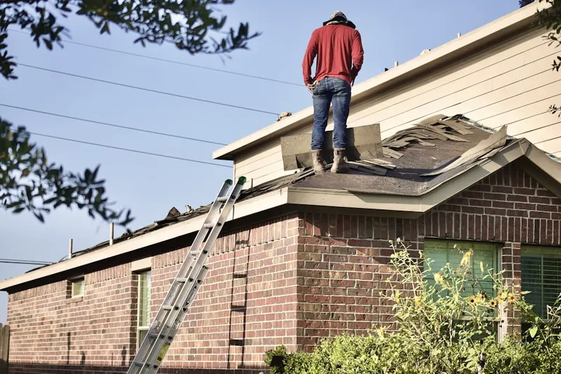 Professional roofer working on a residential roof in Kingsbridge Crossing